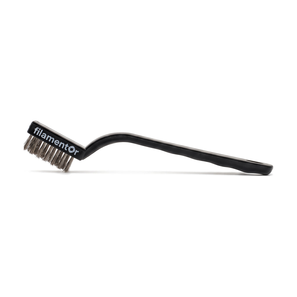 Filamentor wire brush with stainless steel bristles and a black plastic handle, with the filamentor logo on the brush head